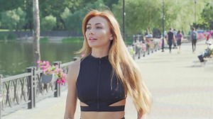 Joyful woman running by the river, embracing fitness and nature