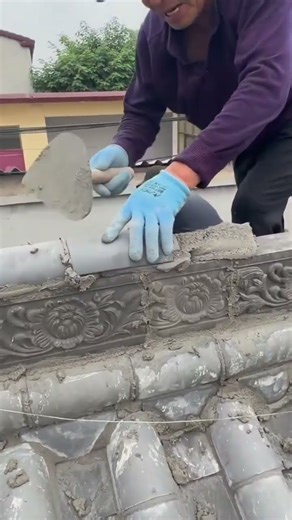 the process of installing curved roof tiles on the roof ridge of a house #construction #popular