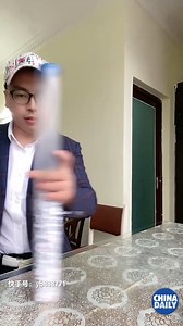 #ChinaStory Dice stacking is the art of stacking dice in a cup and setting the cup down to build a vertical column without toppling them. It's amazing to see so many people, including a child, do it so well. | China Daily