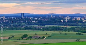 Drone flyby of the Frankfurt skyline in front of a colorful evening sky with light clouds