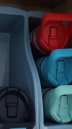 Stop the water bottle avalanche in your cabinets with this easy magazine holder trick. So much better!