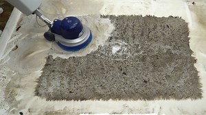 This wool rug was covered in earthworm larvae and caked-on mud after it was discarded in someone's pool. James of Mountain Rug Cleaning gives it a deep clean using a variety of tools, including a high-powered hose, a rotary machine, a counter rotating brush machine, a squeegee, and a watering can. He was able to transform the rug from brown and muddy to white and fluffy. | Insider Home