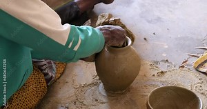 African Woman making a clay pottery jug traditional village Ghana. Northern Ghana art and craft village specializing in pottery, baskets, leather and painting. Income producer for tourism and export