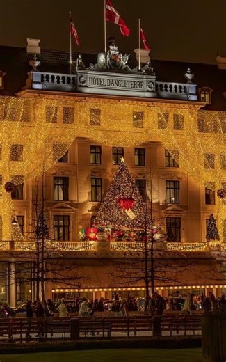 The Leading Hotels of the World on Instagram: "Each December, @dangleterrecph transforms into one of Europe’s most enchanting seasonal retreats. Its neoclassical façade shimmers beneath cascades of lights, hinting at the festive revelry within: candy-hued wreaths, oversized bows suspended from chandeliers, and a trail of sweet scents — sugared almonds, spiced pastries — leading toward @maisondangleterre. Whimsical yet refined, it’s a joyful Danish interpretation of holiday tradition, wrapped in