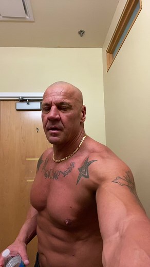 Muscular Man Flexing with Intriguing Tattoos