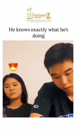 Unviversal Clips on Instagram: "#biggerz The Instagram reel shares a 41-second video of young friends in a casual setting, where a man cleverly positions himself for an affectionate kiss from a woman amid playful group interactions, captioned to emphasise his intentional charm. ' strategy of amplifying light-hearted, relatable humour that resonates through innocent flirtation and quick laughs. Replies celebrate the "trolling" tactic and couple's cuteness, underscoring how such content fosters po