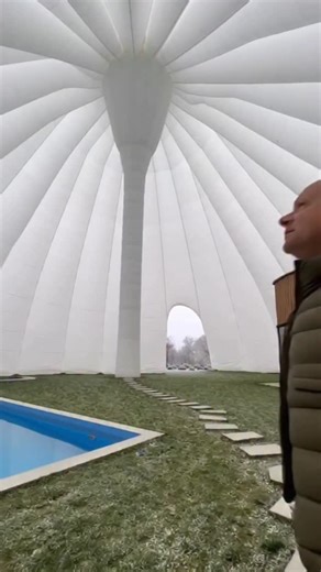 The video shows an inflatable dome structure designed to retain warmth inside. While it’s winter outside, the interior feels like summer, protected from the cold air. The transparent cover creates a greenhouse-like effect. A warm oasis surrounded by freezing temperatures. This text and video are entirely fictional and created using artificial intelligence. | Anatolii Marynyuk