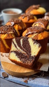 Chocolate Marble Muffins Bakery-style chocolate marble muffins with a moist crumb, beautiful swirls, and chocolate topping, perfect for breakfast or dessert. Ingredients For the vanilla muffin batter All-purpose flour 2 cups (250 g) Granulated sugar ¾ cup (150 g) Baking powder 2 teaspoons Salt ½ teaspoon Eggs 2 large, room temperature Vegetable oil ½ cup (120 ml) Whole milk ¾ cup (180 ml) Vanilla extract 2 teaspoons For the chocolate batter Unsweetened cocoa powder ¼ cup (25 g) Hot milk or hot w
