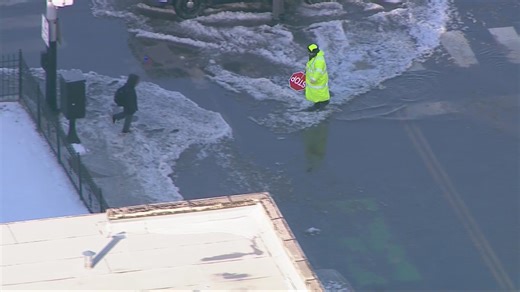 Video: Hero crossing guard carries child across flooded street