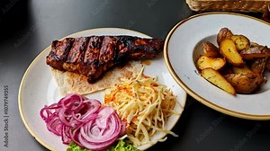 Grilled steak with Greek pita, cabbage salad, onions, and potatoes - restaurant meal