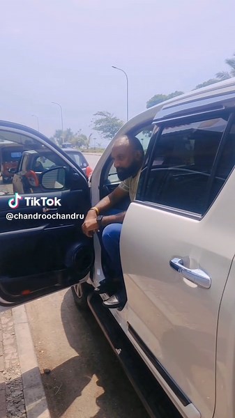 Man Exits White SUV in Urban Setting