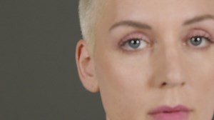 Female model poses for camera in front of grey backdrop 05 | Free Stock Video Footage