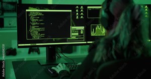 Young cyber security hacker code harmful software to exploit vulnerability in program or system in dark room