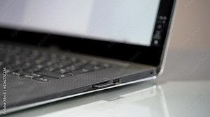 Hand inserting sd card into laptop integrated card reader