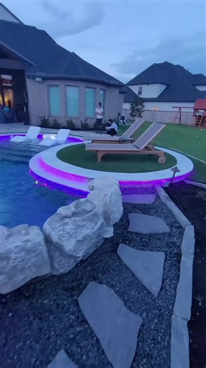 Happy Thursday 🌞✨ 🔥 Modern Freeform Pool Goals 🔥 Check out this next-level freeform pool spa we built— and trust us, this one hits DIFFERENT 👀💦 ✔️ Rock grotto waterfall 🌊 ✔️ Elevated turf decking 🌿 ✔️ Cantilevered structure with an outdoor kitchen underneath 🍔🍹 ✔️ And our FAVORITE… custom LED perimeter lighting that absolutely sets this backyard on fire at night ✨💡 When people hear freeform pool, they usually think old-school and traditional… 🚫 NOT THIS ONE. This is modern, clean, and
