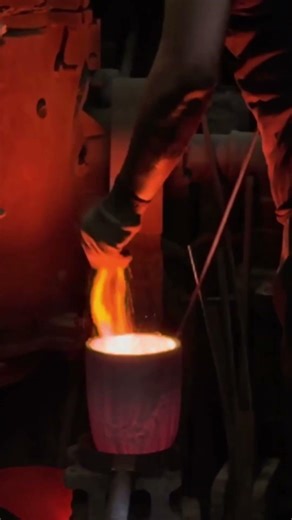 Molten iron at 1,300°C poured into a hand-packed sand mold.