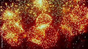 Brilliant bursts of color light up the night as fireworks explode in slow motion, creating a mesmerizing dance of lights against the dark backdrop.