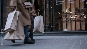 Young women walking with bags after shopping