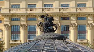 Glass cupola crowned by a statue of Saint George, patron of Moscow, at the Manege Square timelapse hyperlapse in Moscow, Russia. Historic buildings on a background. Close up view