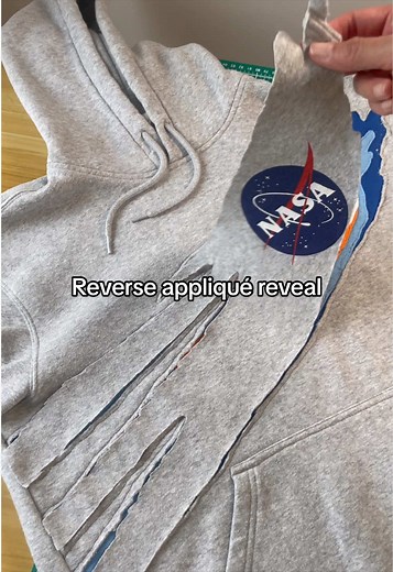 NASA hoodie upcycle. Using reverse appliqué and free motion embroidery to flip this thrifted hoodie. #upcycledfashion