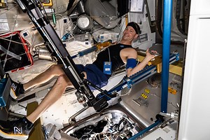 Astronaut Nick Hague exercises on the advanced resistive exercise device