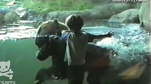 Boy and bear play follow the leader