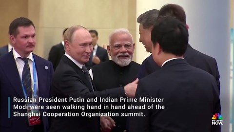 Putin and Modi hold hands ahead of meeting with Xi