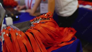 Process of checking in on conference congress forum event, registration desk table, visitors and attendees receiving lanyard with name badge and entry wristband bracelet and register electronic ticket