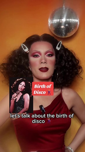 Disco was truly a magical scene that was born as a response to oppression 🪩🕺💃. Video description: Taipei is a drag queen in curly brown hair and a red dress in front of an orange background. A disco ball is spinning above her. She describes the history of the creation and mainstream success of disco. Reference images are shown on the screen. #disco #musichistory #fashionhistory #queerhistory #70sfashion #70smusic