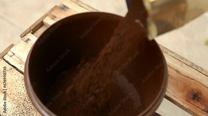 Ground coffee on the table. Slow tilting movement: pouring coffee powder into a pot. Black coffee powder. Bowl of coffee powder, top view. Coffee powder on the table. Pouring ground coffee into a bowl
