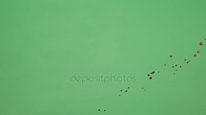 Red Ink Splatter Over Green Screen Background