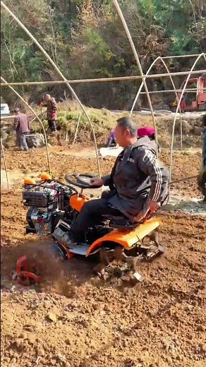 Tilling Soil: Small Tractor Prepares Field for Planting