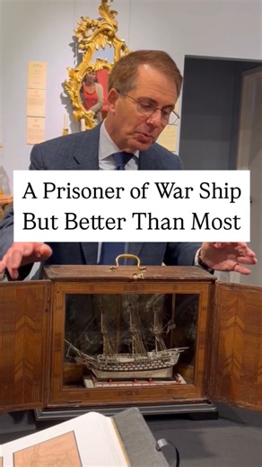 This exceptional Napoleonic-era ship model is a rare artifact of maritime history, representing the legendary HMS Victory—Admiral Lord Nelson's flagship at the Battle of Trafalgar. Created circa 1800 by a French prisoner of war, this remarkable three-masted vessel was meticulously crafted from mutton bones with intricate deck fittings, rigging, lifeboats, a British ensign, and an ornate beakhead, all housed in an extraordinarily rare Tunbridge Ware case with hinged glass front and mirrored back.