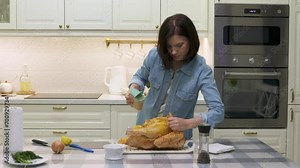woman cooking roasted stuffed turkey in kitchen, thanksgiving and christmas holiday dinner Stock Video