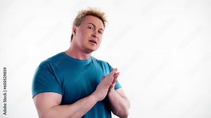 Sarcastic, disapproval dislike gesture and man clapping critique and rejection expression. Displeased smiling unhappy guy looking at camera in studio isolated on white background.