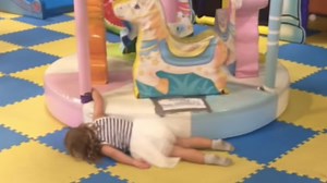 Little girl getting dragged by a merry-go-round is too relatable