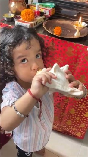 Baby trying to blow a conch shell shankh sound #shorts #minishorts #funnyshorts #trendingshorts