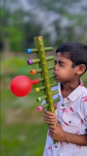 A large toy with a coconut tree branch and balloons #diy #art