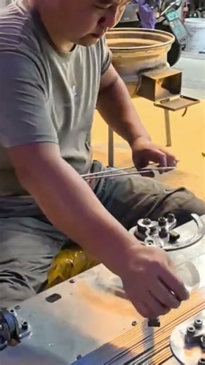 The process of making clothes hangers using special tools that are being operated by a worker