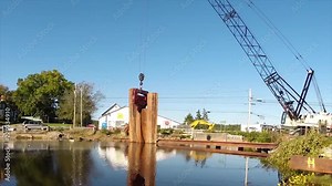 Construction of a cofferdam to keep the water level rising so a new bridge can be built Stock Video