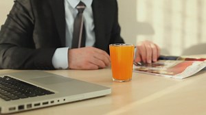 Man in suit flipping through a magazine - Free Stock Video