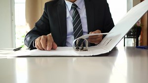 Download Businessman signing business contract on paper documents. for free