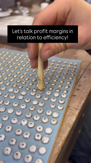 Be A Maker School on Instagram: "Profit margins increase when efficiency increases! One such instance is with my STRAND bench beads instead of brushing each half with white out to prevent soldering from filling the stampwork we developed a “stamp” using the end of a flux brush and a couple layers of foam that we dipped in the white out then pressed into each bead. Huge difference in time! What are some efficiency hacks you use? @nevadaw #BAMS #beamakerschool #silversmithing #efficiencyunlocked #