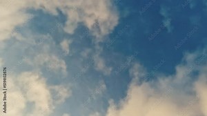 Fast Moving Cloud Time Lapse Background. Light and fluffy low cloud cover moves in front of heavier clouds in the distance. Fast-moving time lapse against a beautiful blue sky.
