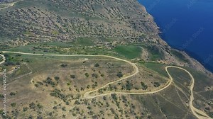 View of the bay at Cape Meganom, Crimea. Aerial video of cliffed coast line cape Meganom Crimea Rocks line the shore of Black sea. 4K.