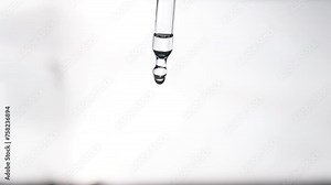 Pipette with cosmetic oil close up on a white glowing background. Cosmetic procedures. Serum