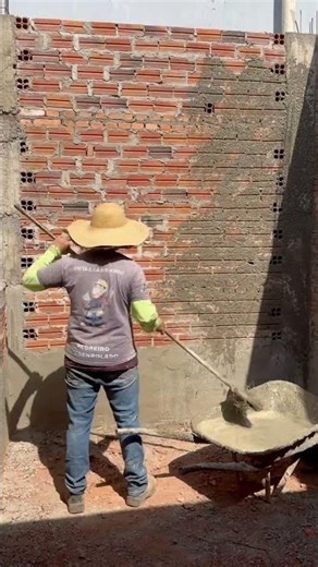 Applying a coat of plaster