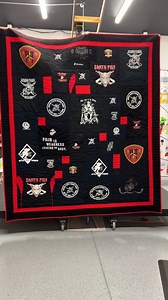 This is a T-shirt Quilt we made for a Marine. All the T-shirts were black, but they wanted some color. The red is just stunning! We love how to turned out! And the back of the quilt - just as awesome as the front! #MarineCorps #USMC #VeteranGift #MilitaryMemories #MarineVeteran #RetiredMarine #TshirtQuilt #UltraModernQuilt #TooCoolTshirtQuilts #ModernQuiltDesign #CustomQuilt #MemoryQuilt #MilitaryFamily #QuiltInspo #HomeDecor #OneOfAKind #VeteranPride | Too Cool T-Shirt Quilts