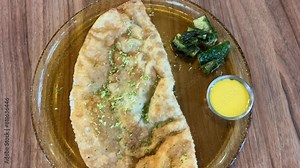 woman cooking homemade pasties frying chebureks in kitchen at home