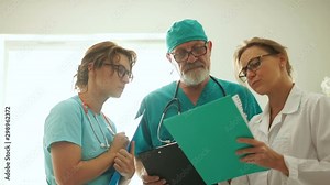 Three doctors conferring against the window in an emergency hospital, emergency conditions, emergency surgery
